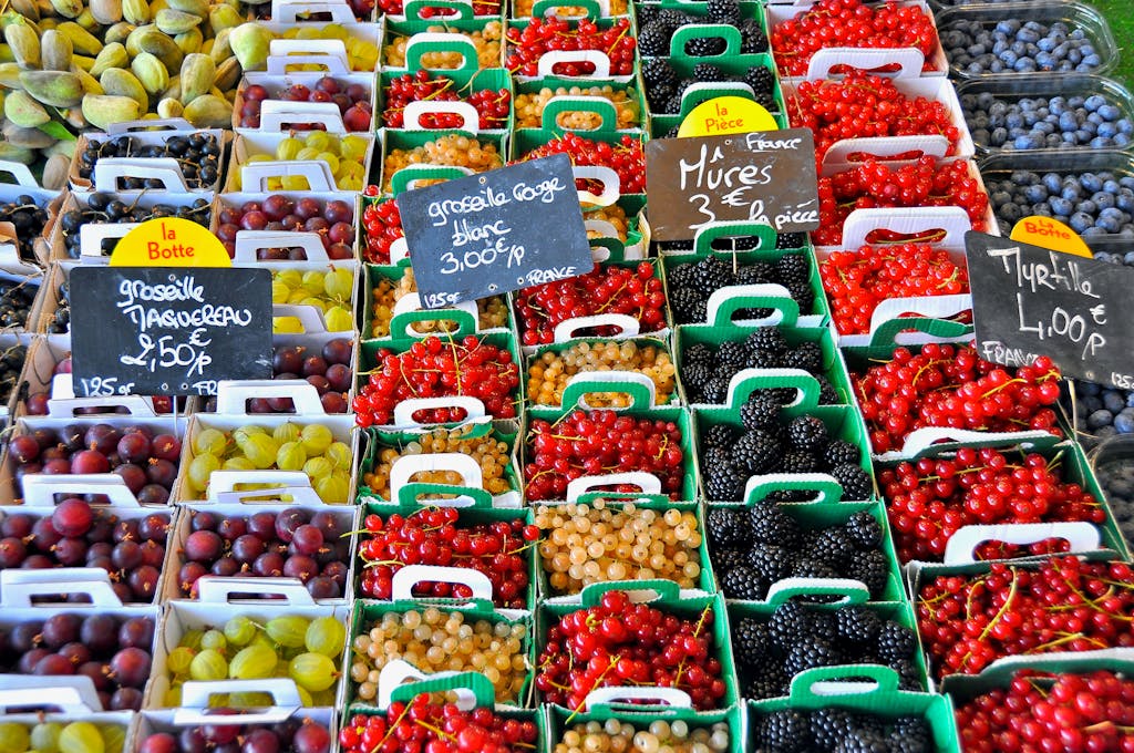 A vibrant display of assorted berries for sale at a market in Le Bois-Plage-en-Ré, France.